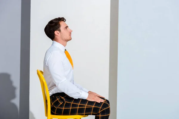 Side View Man Plaid Trousers Sitting White Grey — Stock Photo, Image