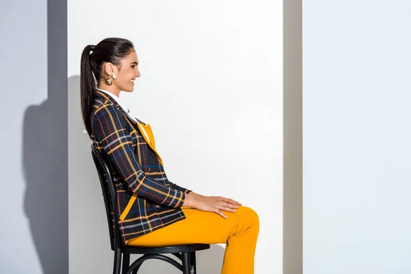 Side View Cheerful Young Woman Sitting Chair Grey White — Stock Photo, Image