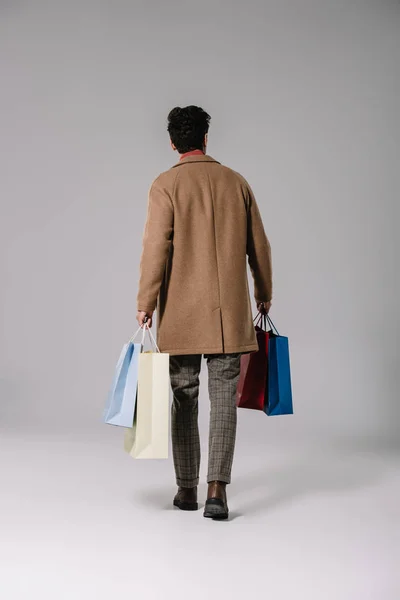 Rear View Man Beige Coat Holding Shopping Bags Grey — Stock Photo, Image