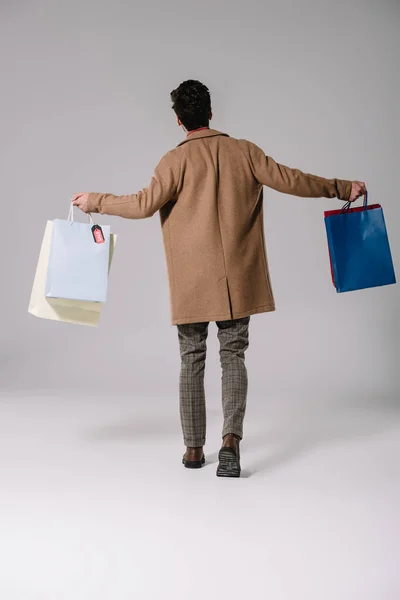 Back View Stylish Man Beige Coat Walking Shopping Bags Grey — Stock Photo, Image