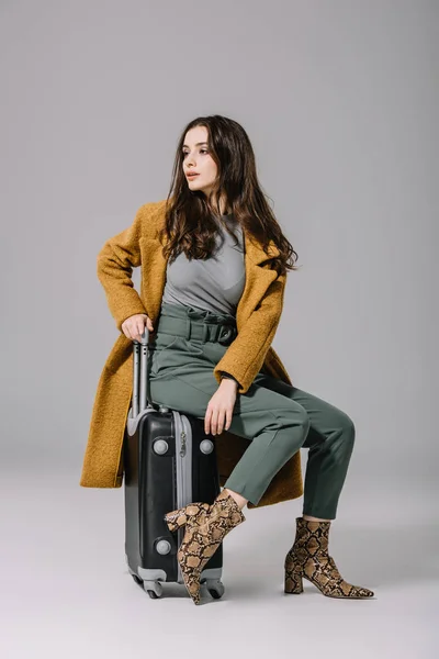Fashionable Girl Beige Coat Sitting Travel Bag Grey — Stock Photo, Image
