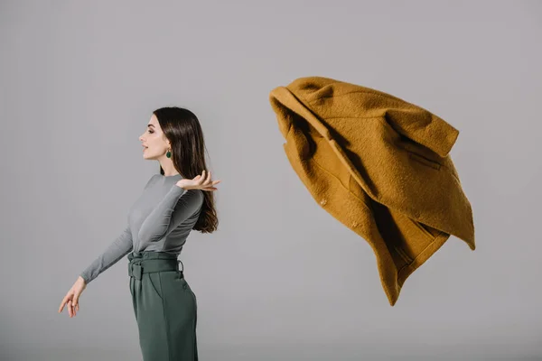 Beautiful Elegant Girl Throwing Beige Coat Isolated Grey — Stock Photo, Image