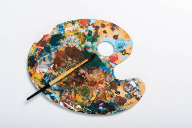 top view of palette with colorful gouache paint isolated on white  clipart
