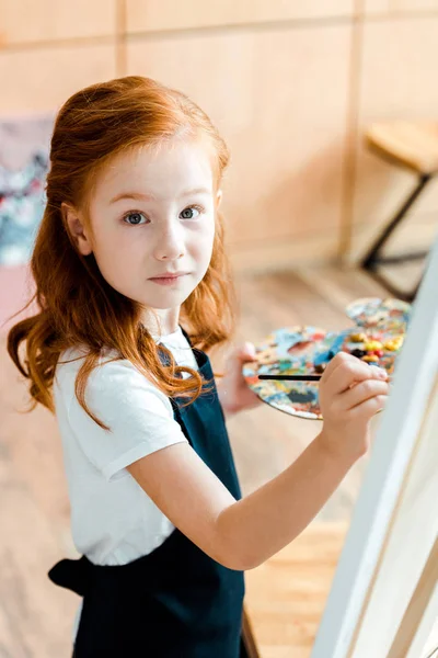 Selective Focus Redhead Child Holding Paintbrush Looking Camera — Stock Photo, Image