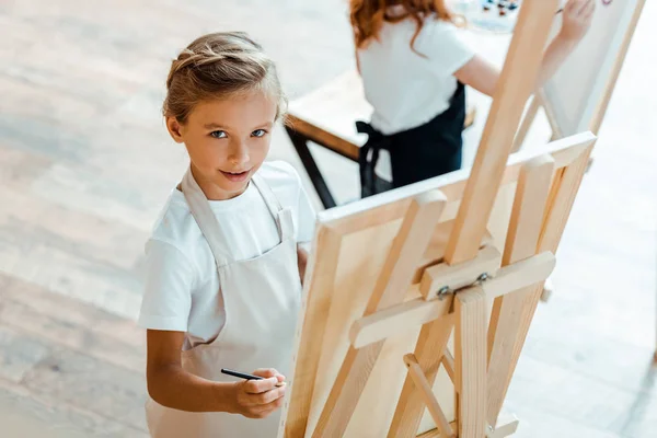 Overhead View Cute Kid Looking Camera Art School — Stockfoto