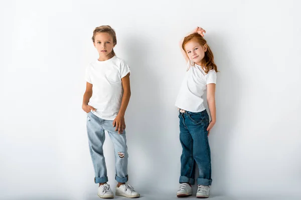穿着斜纹棉布牛仔裤站在白边上的可爱孩子 — 图库照片