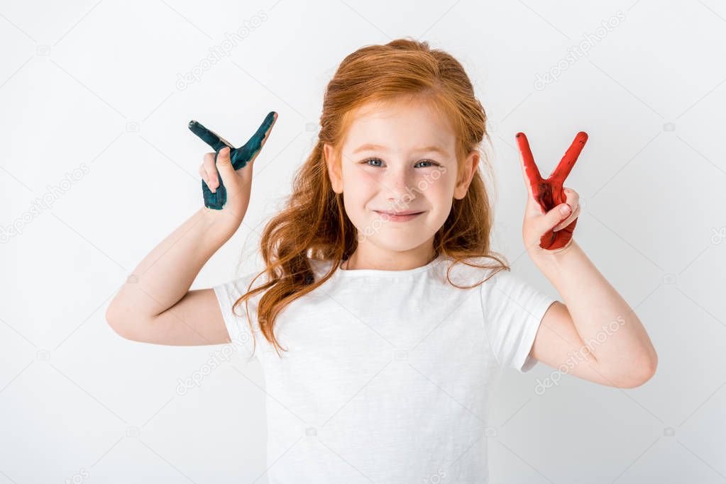 cheerful redhead kid with paint on hands showing peace sign isolated on white 