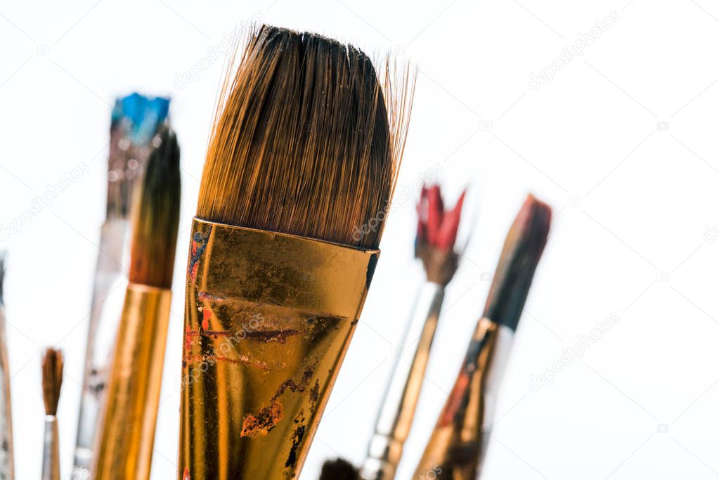 close up of paintbrushes with paint isolated on white 