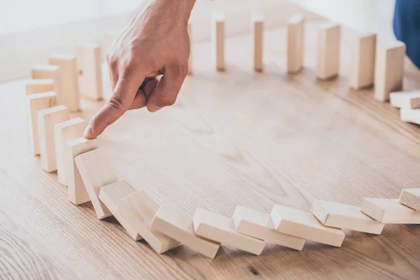 Cropped View Risk Manager Stopping Domino Effect Falling Wooden Blocks — Stock Photo, Image