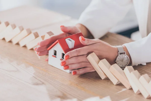 Cropped View Risk Manager Protecting House Model Falling Wooden Blocks — Stock Photo, Image