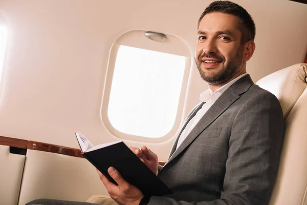 Cheerful Businessman Holding Notebook Private Jet — Stock Photo, Image