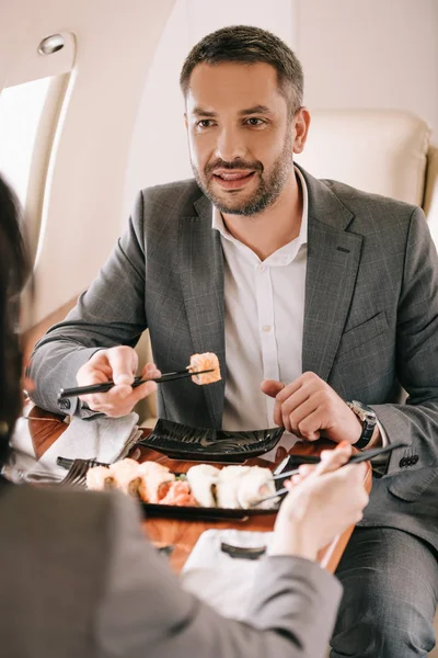 Cropped View Businesswoman Bearded Businessman Tasty Sushi Private Jet — Stock Photo, Image