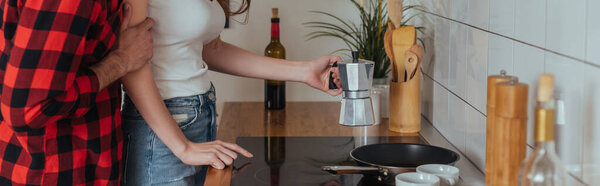 cropped view of man touching girlfriend making coffee in geyser coffee maker, horizontal image