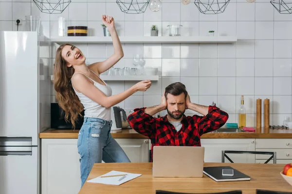 Cheerful Girl Fooling Dancings Boyfriend Covering Ears Hands While Sitting — Stock Photo, Image