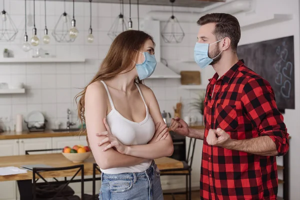 Young Couple Medical Masks Quarreling While Girl Standing Crossed Arms — Stock Photo, Image