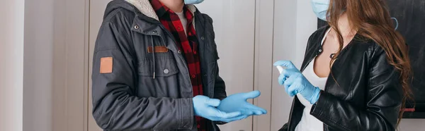 Partial View Couple Medical Masks Latex Gloves Using Antiseptic Spray — Stock Photo, Image