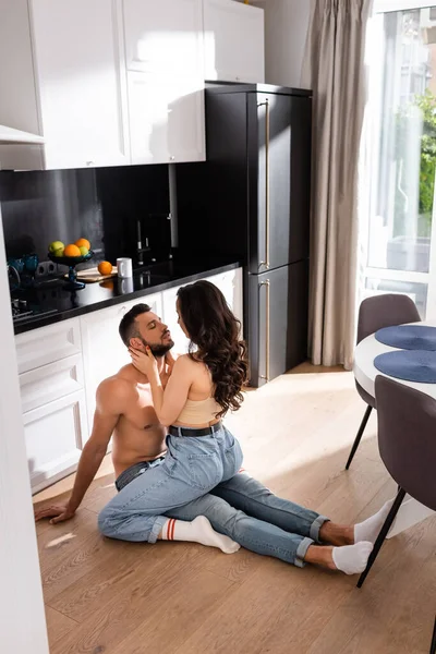 Young Woman Sitting Touching Muscular Boyfriend Kitchen — Stock Photo, Image