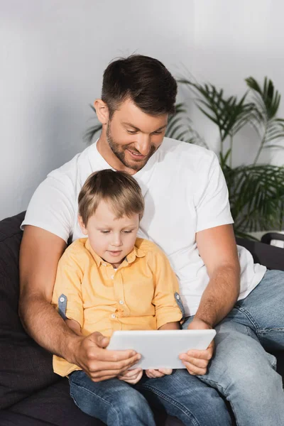 Happy Father Attentive Son Sitting Sofa Using Laptop Together — Stock Photo, Image
