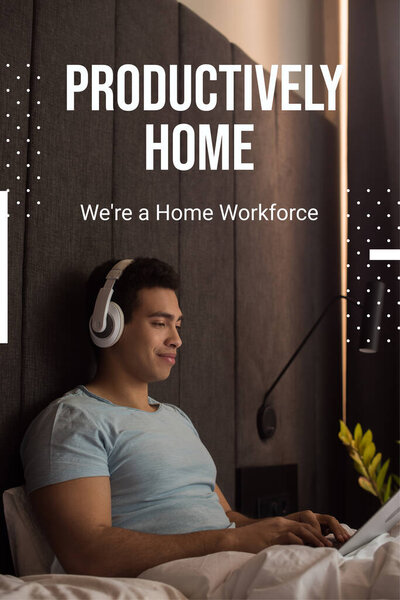 bi-racial man listening music in headphones and using laptop near productively home, were a home workforce lettering 