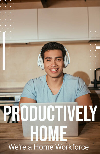 smiling bi-racial man listening music in headphones and using laptop near productively home, were a home workforce lettering 