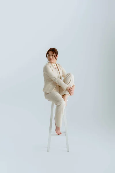 Barefoot Businesswoman Looking Away While Sitting Chair Grey Background Concept — Stock Photo, Image