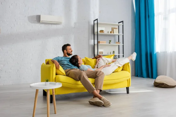 Smiling Woman Lying Handsome Man Yellow Couch Home — Stock Photo, Image