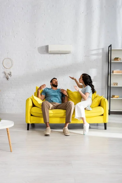 Young Woman Blowing Boyfriend Suffering Heat Couch Living Room — Stock Photo, Image