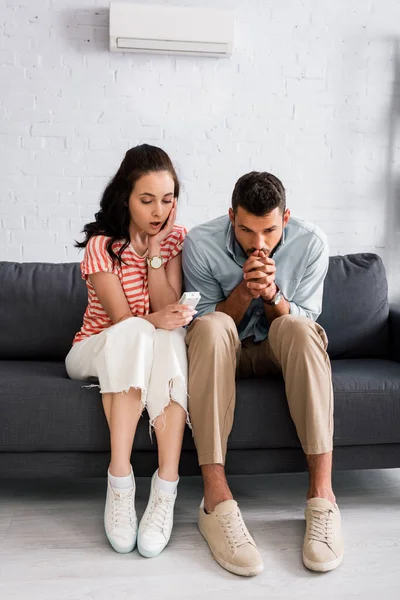 Shocked Woman Holding Remote Controller Air Conditioner Boyfriend Feeling Cold — Stock Photo, Image