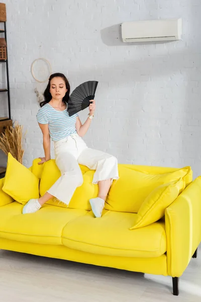 Beautiful Girl Waving Fan While Sitting Sofa Living Room — ストック写真