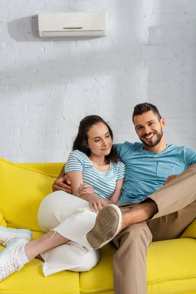 Handsome Man Smiling Camera While Hugging Attractive Girlfriend Couch Living — Stock Photo, Image