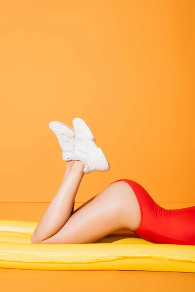 Cropped View Girl Swimsuit Sneakers Lying Inflatable Mattress Orange — Stock Photo, Image