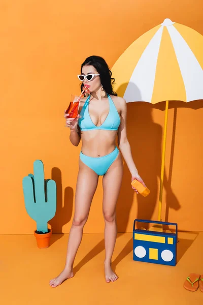 Young Woman Swimwear Sunglasses Holding Sunscreen Drinking Cocktail Paper Umbrella — Stock Photo, Image