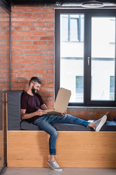 Selective Focus Cheerful Businessman Sitting Window Bench Holding Pizza Box — Stock Photo, Image