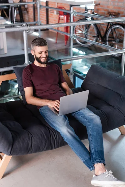Hombre Negocios Sonriente Sentado Sofá Uso Ordenador Portátil Oficina —  Fotos de Stock