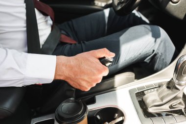 Resmi olarak işadamlarının manzarası kahvenin yanında araba sürerken bardak tutacağının içine giriyor.