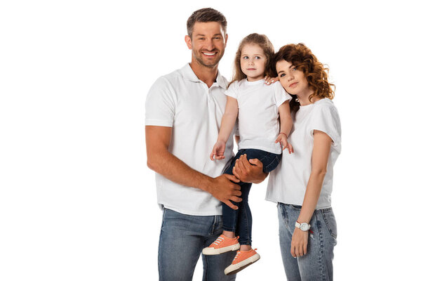 cheerful father holding in arms cute daughter and standing with curly wife isolated on white