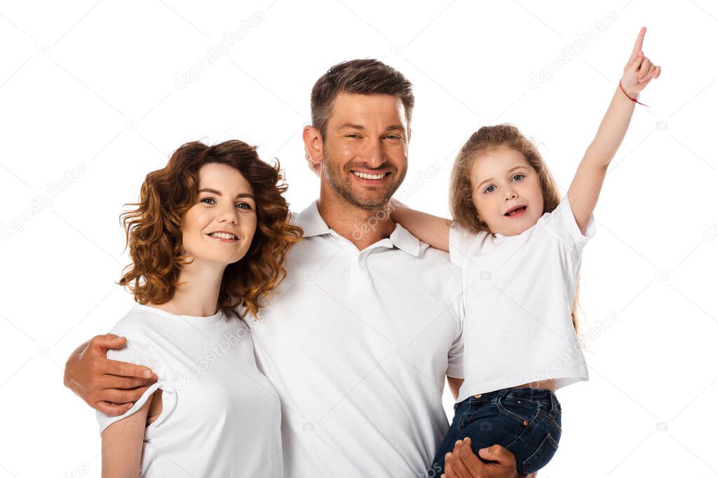 happy father holding in arms cute daughter pointing with finger near curly wife isolated on white