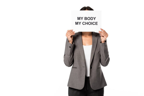 businesswoman covering face while holding placard with my body my choice lettering and standing isolated on white