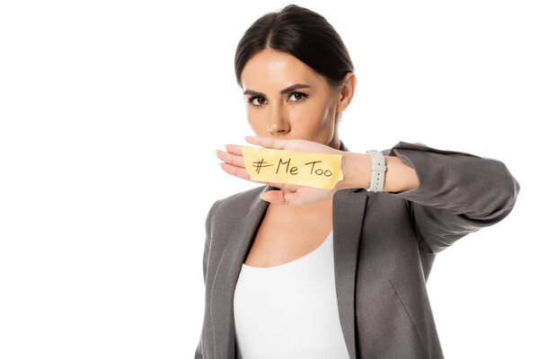 businesswoman with me too lettering on hand covering mouth and looking at camera isolated on white, gender inequality concept 