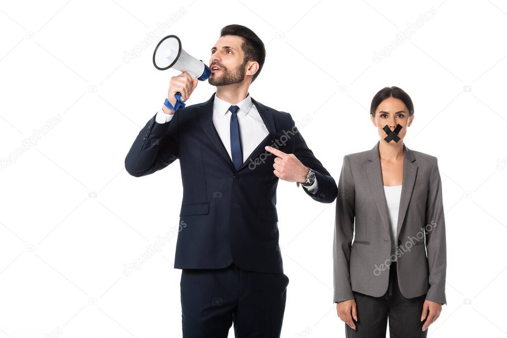 bearded businessman pointing with finger while screaming in megaphone near businesswoman with duct tape on mouth isolated on white