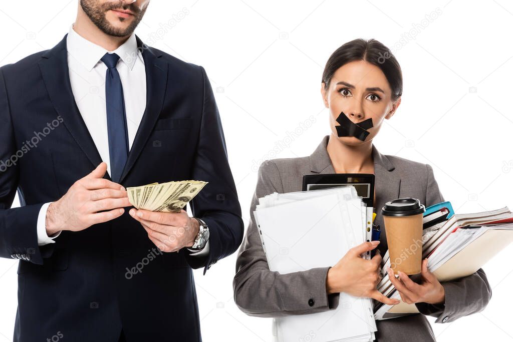 bearded businessman holding dollars near businesswoman with duct tape on mouth isolated on white, sexism concept 