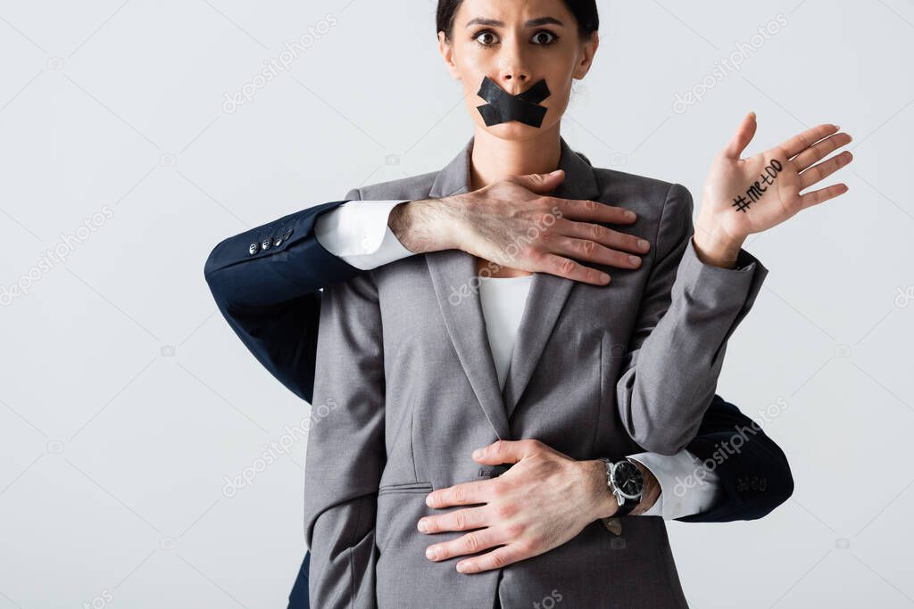 businessman molesting businesswoman with scotch tape on mouth showing hand with me too lettering isolated on white