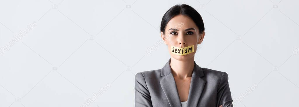 website header of businesswoman with sexism lettering on scotch tape isolated on white 
