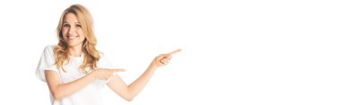 smiling attractive adult woman pointing with fingers aside isolated on white, panoramic shot clipart