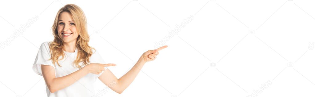 smiling attractive adult woman pointing with fingers aside isolated on white, panoramic shot
