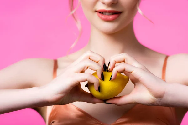 ピンク色に孤立した熟したレモンを引き裂く女性のクロップドビュー 選択的フォーカス — ストック写真