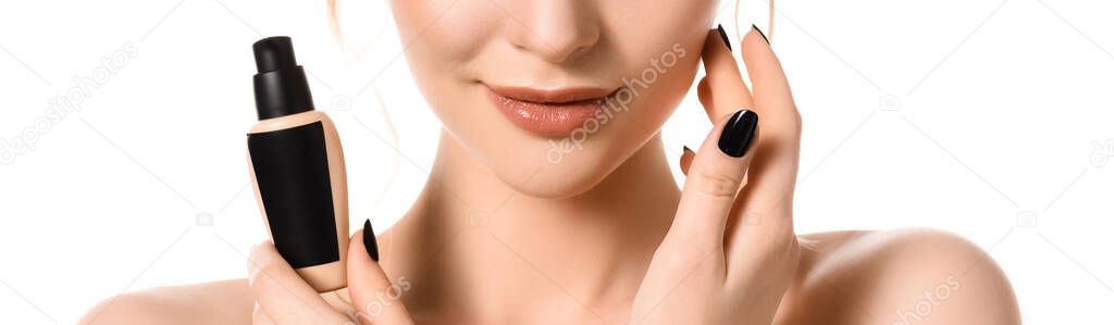 cropped view of smiling naked beautiful woman with makeup and black nails holding face foundation isolated on white, panoramic shot