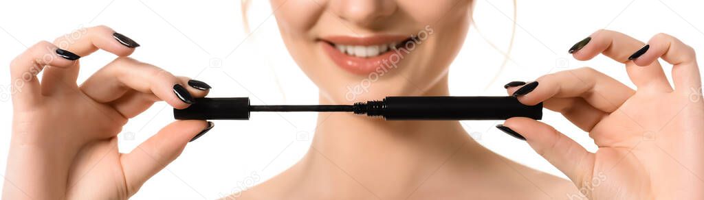 cropped view of smiling naked beautiful woman with makeup and black nails holding mascara isolated on white, panoramic shot
