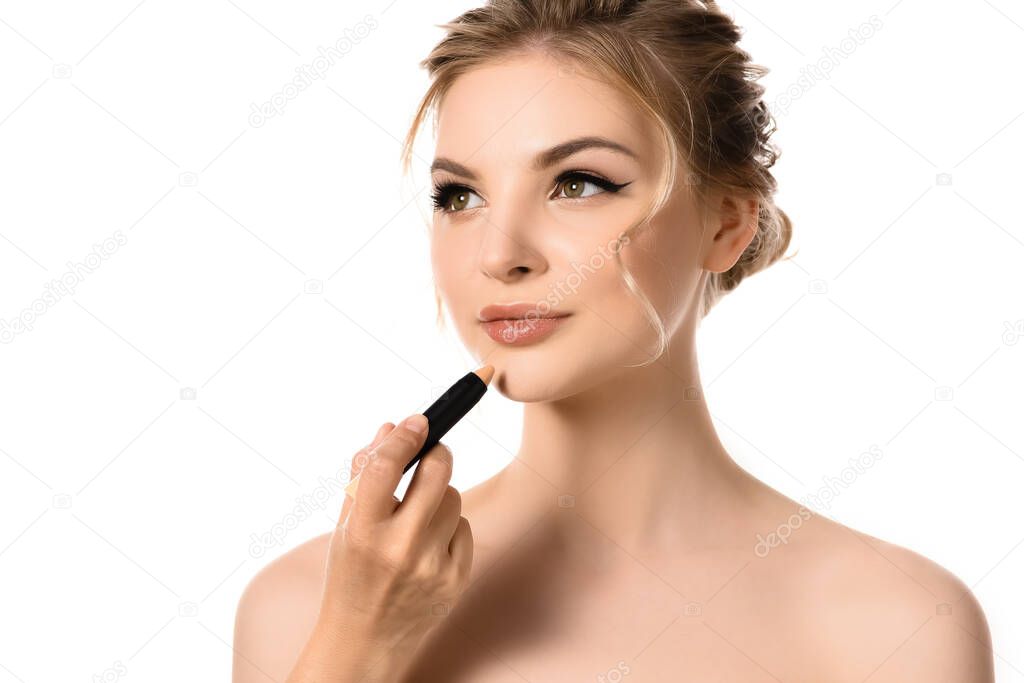hand with concealer near naked beautiful blonde woman isolated on white