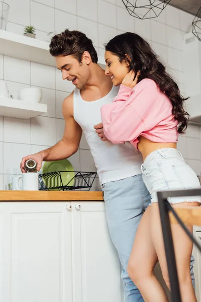 Selective Focus Cheerful Man Pouring Tea Cup Smiling Girlfriend Kitchen — Stock Photo, Image